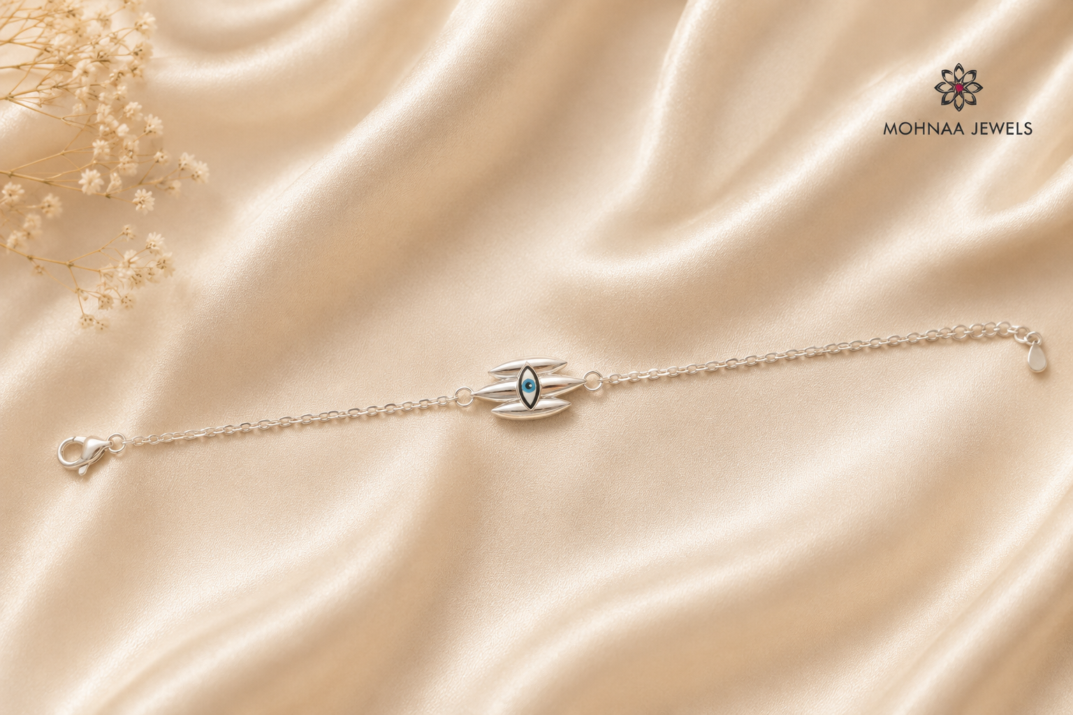 Trinetra 925 Silver Rakhi featuring a protective eye-inspired motif crafted in sterling silver with an adjustable chain, displayed on a luxurious beige satin background by Mohnaa Jewels.