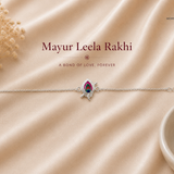"Mayur Leela Rakhi crafted in 925 sterling silver featuring an elegant peacock feather (morpankh) motif with colorful enamel detailing and an adjustable silver chain, beautifully designed for Raksha Bandhan by Mohnaa Jewels."