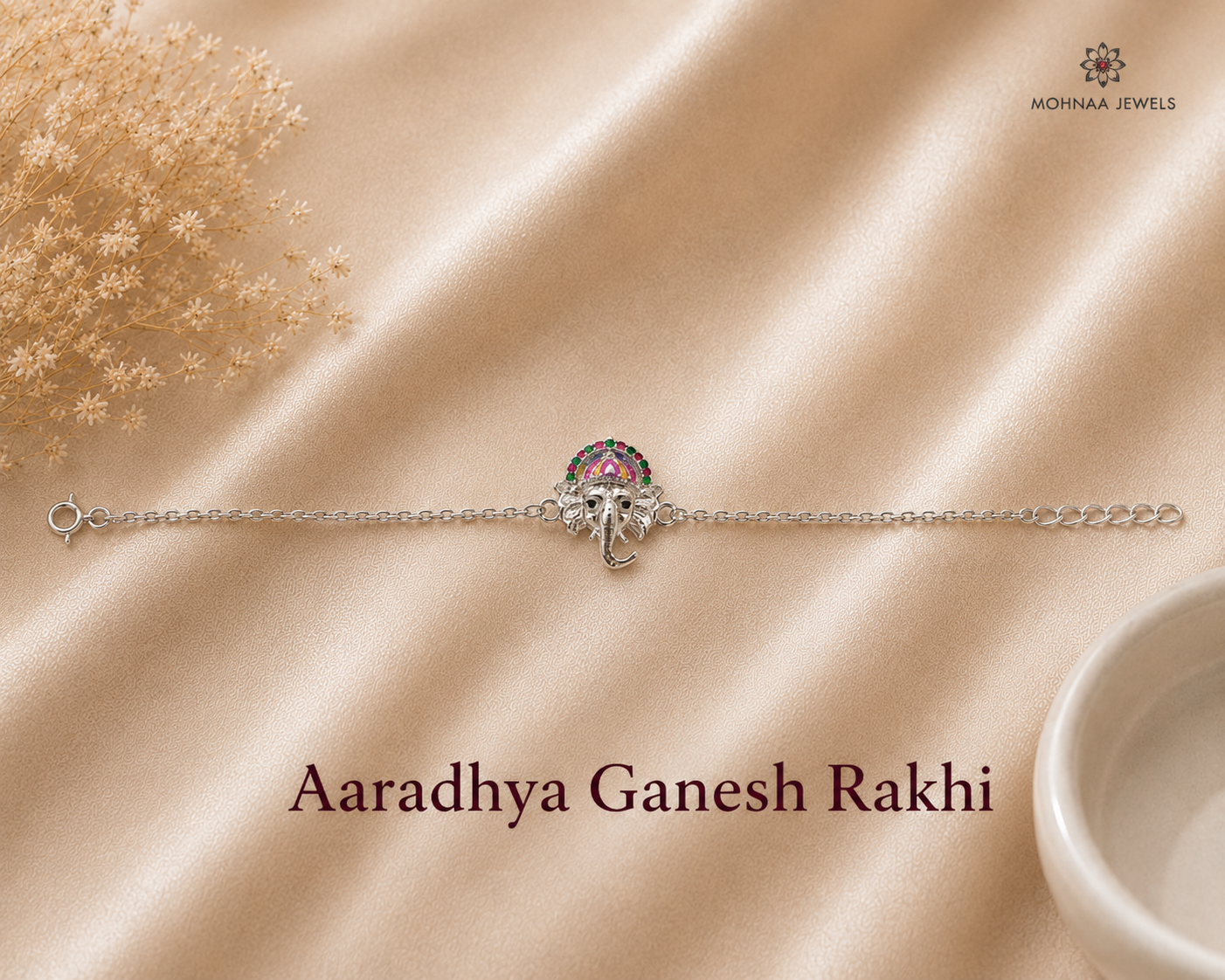 Aaradhya Ganesh Rakhi in 925 sterling silver featuring an enamel Lord Ganesha motif with adjustable silver chain by Mohnaa Jewels.