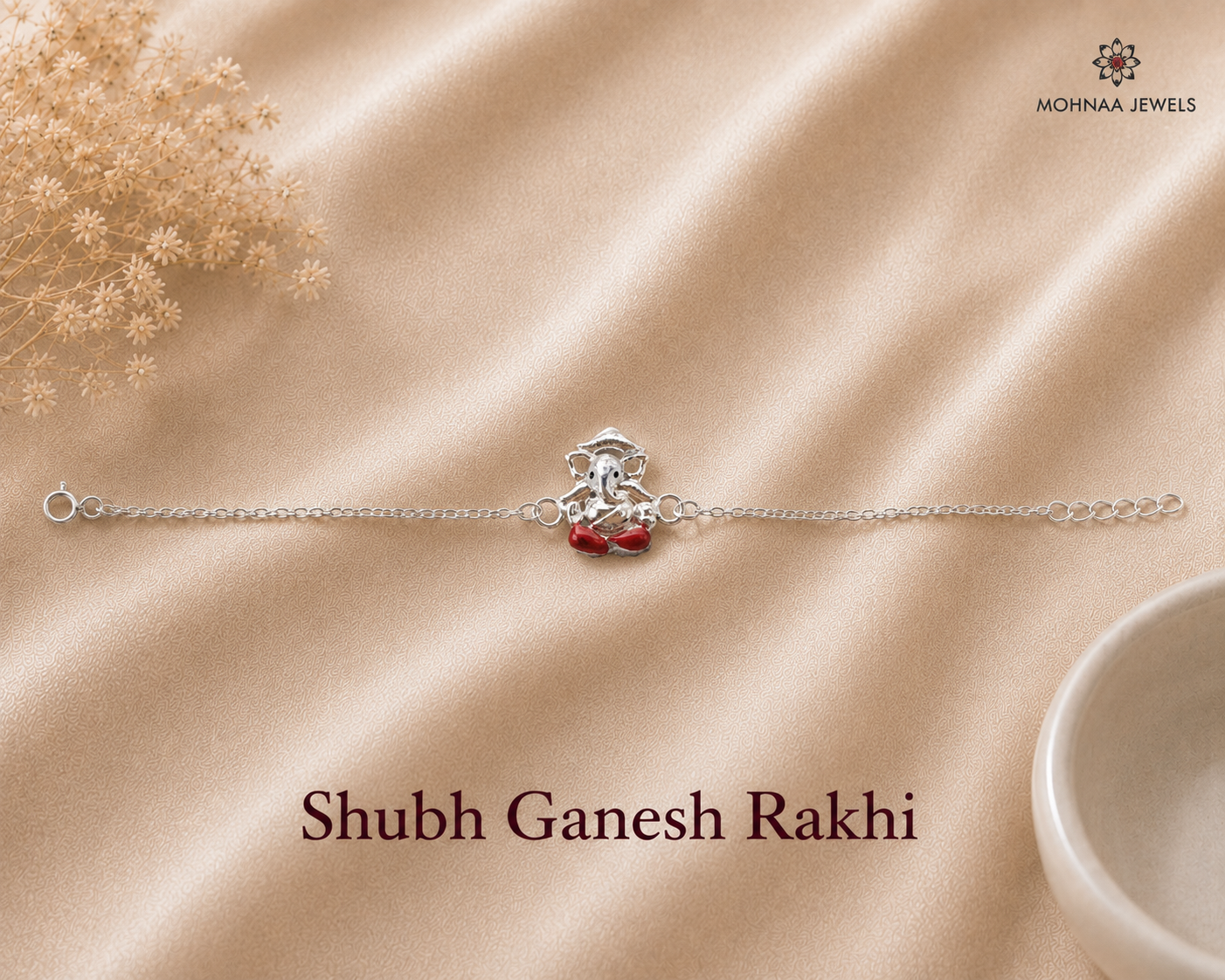 Shubh Ganesh Rakhi crafted in 925 sterling silver featuring a seated Lord Ganesha motif with red enamel accents and adjustable silver chain by Mohnaa Jewels.
