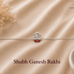 Shubh Ganesh Rakhi crafted in 925 sterling silver featuring a seated Lord Ganesha motif with red enamel accents and adjustable silver chain by Mohnaa Jewels.