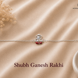 Shubh Ganesh Rakhi crafted in 925 sterling silver featuring a seated Lord Ganesha motif with red enamel accents and adjustable silver chain by Mohnaa Jewels.