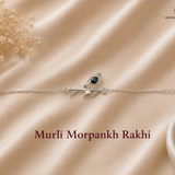 "Murli Morpankh Rakhi crafted in 925 sterling silver featuring Lord Krishna's flute and peacock feather motif with colorful enamel detailing and an adjustable silver chain by Mohnaa Jewels.