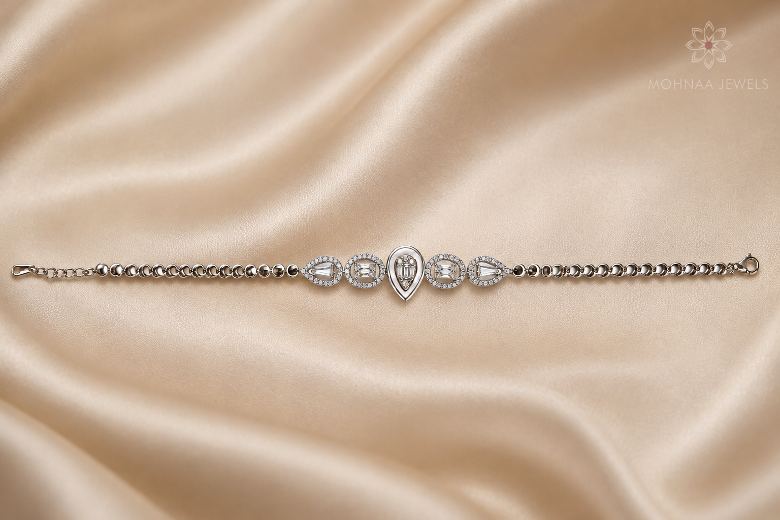 Celestial Dewdrop 925 sterling silver bracelet displayed on a luxurious beige satin background, showcasing pear-cut and baguette-cut sparkling stones.