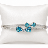 IRA Azure Bloom Bracelet crafted in 925 sterling silver featuring sparkling blue pear-cut stones, floral-inspired detailing, and brilliant CZ accents.