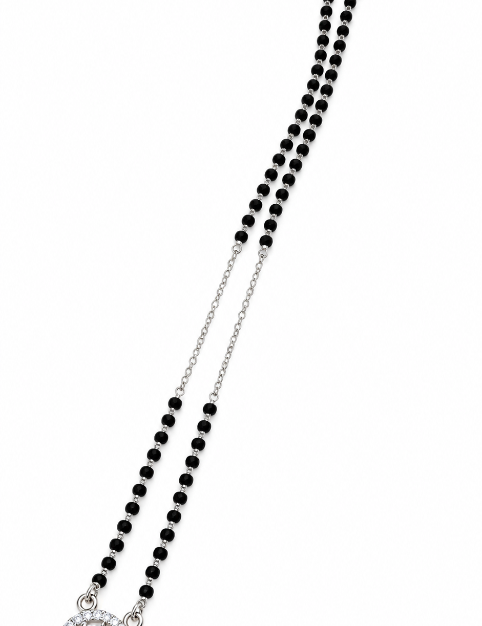 Mohnaa Rivaaya 925 sterling silver mangalsutra featuring a double-chain design with black beads and a sparkling circular halo pendant on a white background.