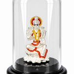 Silver-plated Goddess Lakshmi idol with red and golden accents under a transparent dome on a black display base