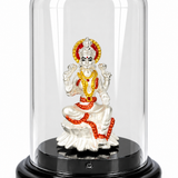 Silver-plated Goddess Lakshmi idol with red and golden accents under a transparent dome on a black display base