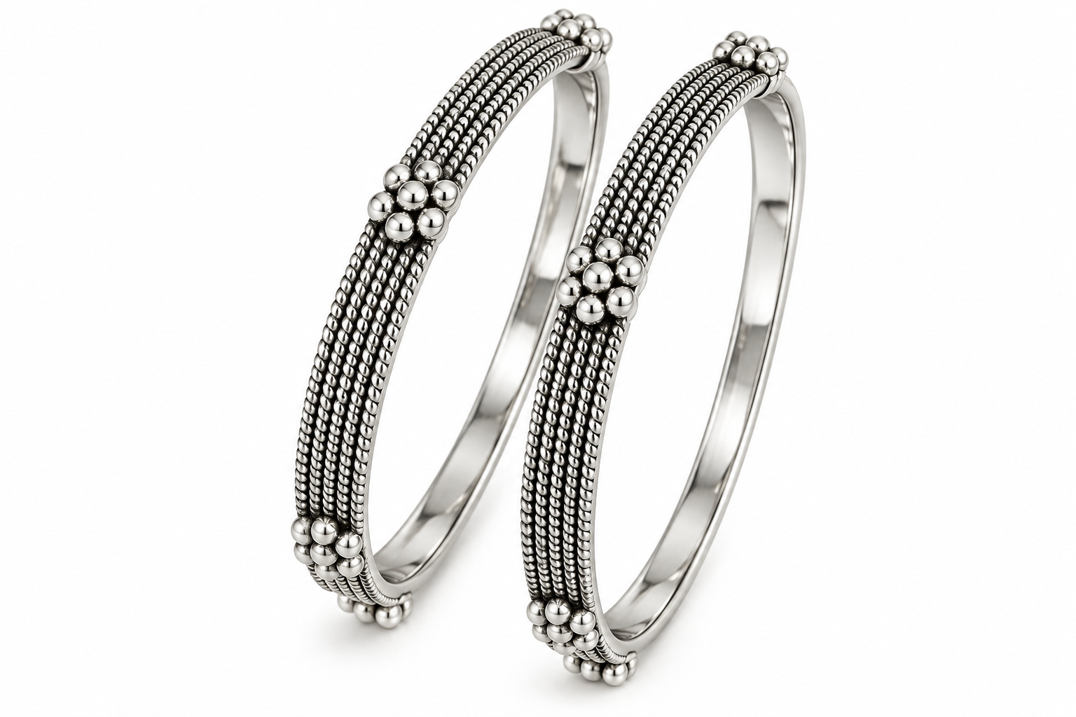 Pair of Tarini handcrafted 925 sterling silver bangles featuring intricate multi-row beadwork and floral silver accents