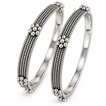 Pair of Tarini handcrafted 925 sterling silver bangles featuring intricate multi-row beadwork and floral silver accents