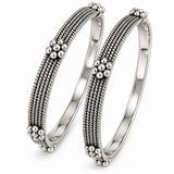 Pair of Tarini handcrafted 925 sterling silver bangles featuring intricate multi-row beadwork and floral silver accents