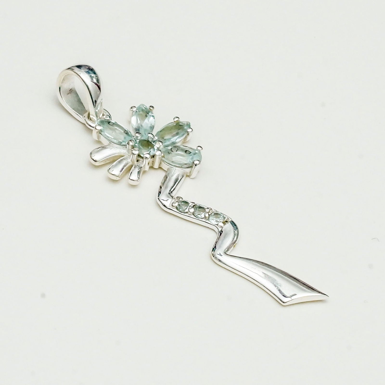 Modern Flower Pendent With Blue Topaz Gemstone In Solid Sterling Silver