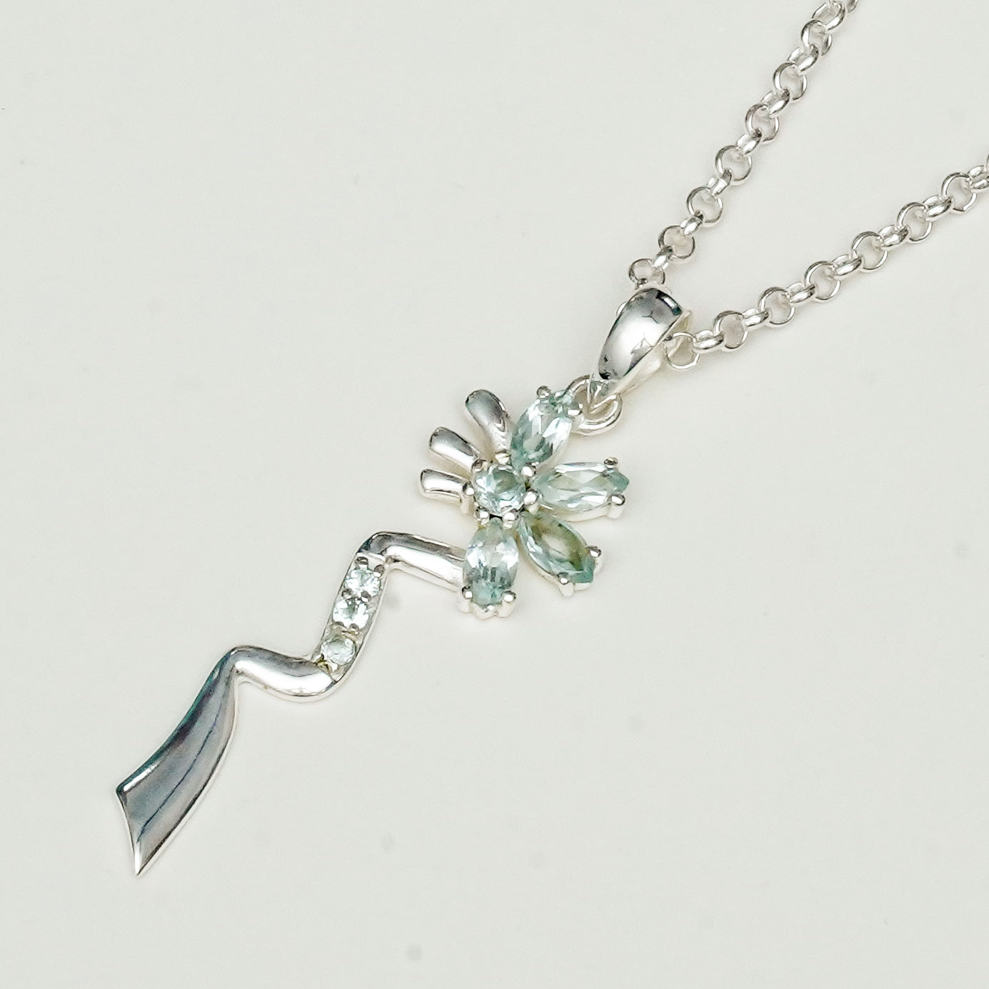 Modern Flower Pendent With Blue Topaz Gemstone In Solid Sterling Silver