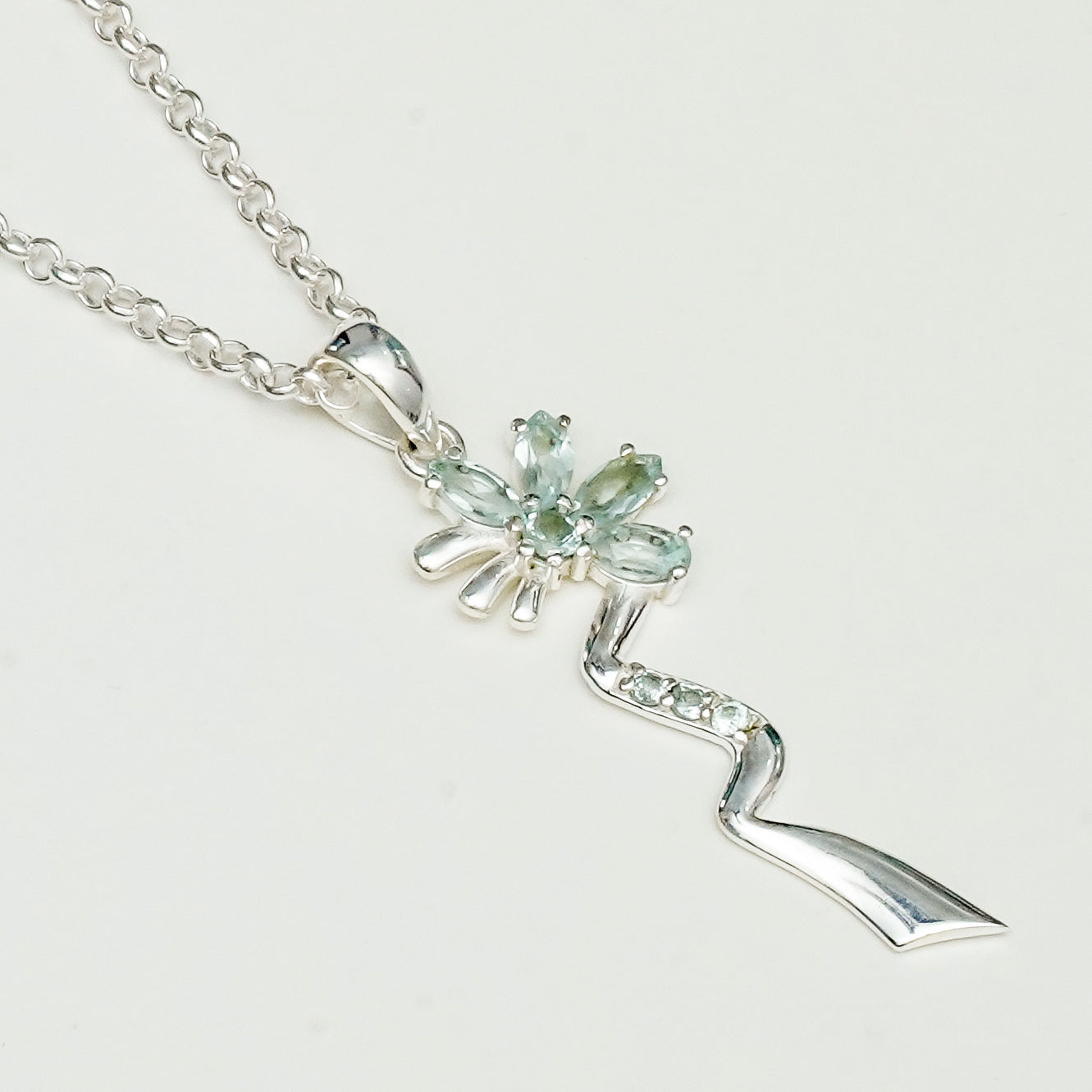 Modern Flower Pendent With Blue Topaz Gemstone In Solid Sterling Silver