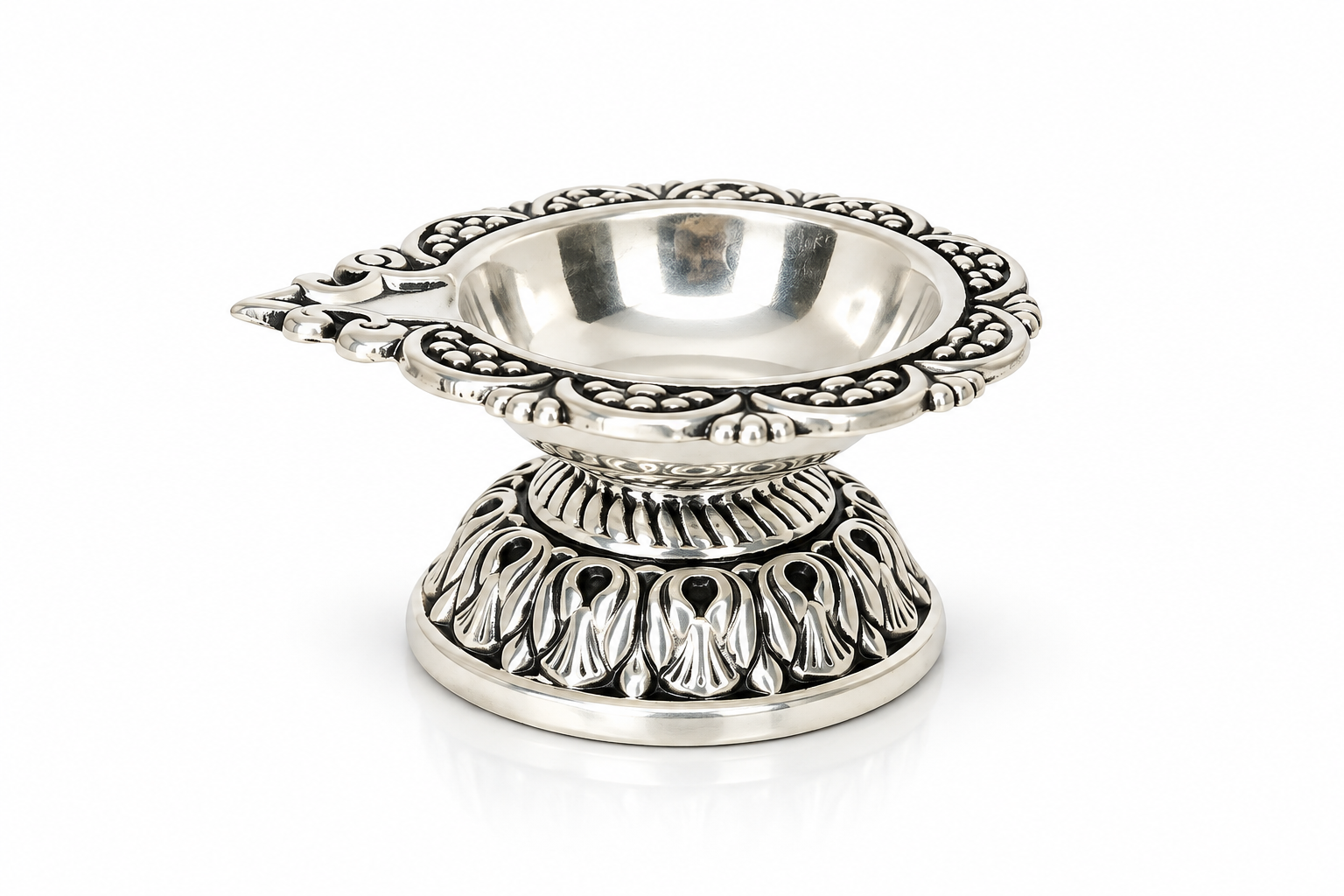 Top view of Mohnaa Shreepad sterling silver diya showing the decorative scalloped rim, polished inner bowl, and traditional ornamental design.