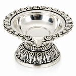 Mohnaa Shreekamal 925 sterling silver ornate diya featuring a scalloped decorative rim, polished bowl, and intricately patterned pedestal on a white background.