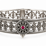 Rajnandini Filigree Kada handcrafted in 925 sterling silver with intricate openwork floral design and ruby-colored center stone.