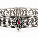 Rajnandini Filigree Kada handcrafted in 925 sterling silver with intricate openwork floral design and ruby-colored center stone.