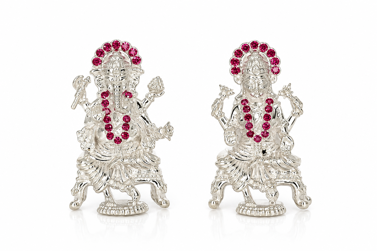 Pair of Mohnaa Jewels 925 sterling silver Lakshmi and Ganesha idols featuring pink stone embellished halos, intricate traditional detailing, and decorative pedestal bases on a white background.