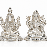 Silver-finish Goddess Lakshmi and Lord Ganesha idol set with intricate traditional detailing