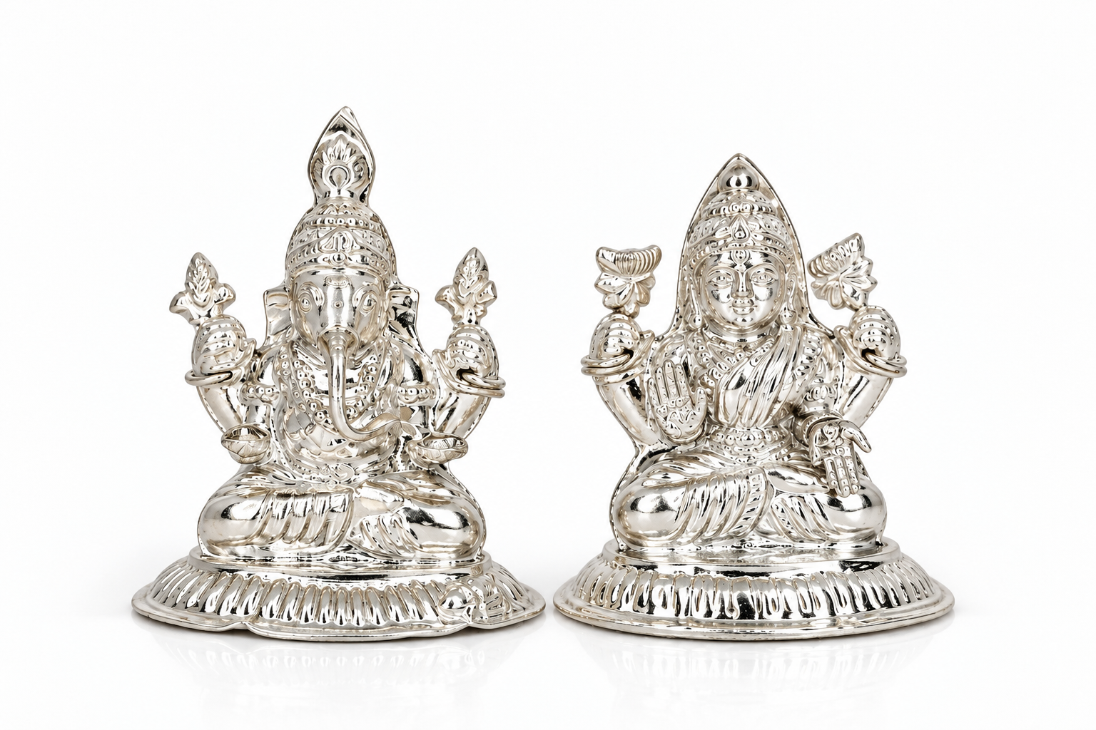 Silver-finish Goddess Lakshmi and Lord Ganesha idol set with intricate traditional detailing