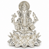 Lord Ganesha seated on an elaborate lotus throne with an ornate crown and decorative halo in silver finish