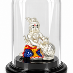 Silver-plated Bal Gopal idol with colourful traditional attire and butter pot under a transparent dome on a black base