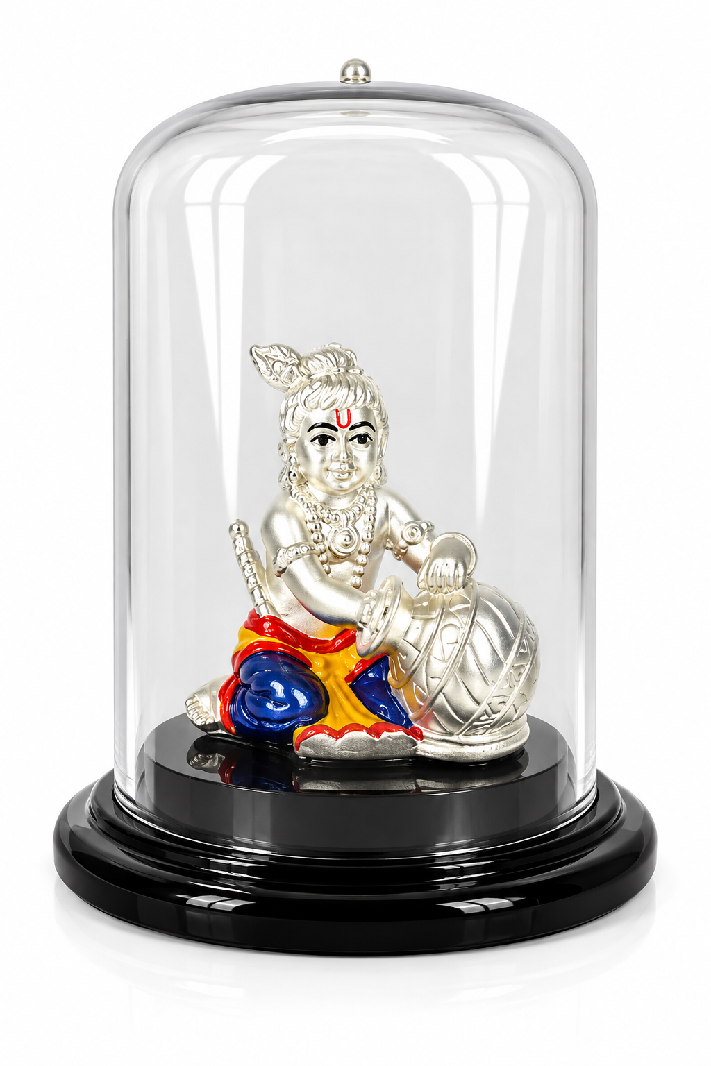 Silver-plated Bal Gopal idol with colourful traditional attire and butter pot under a transparent dome on a black base