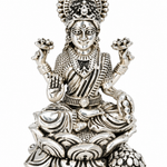 Goddess Lakshmi seated on an intricately detailed lotus throne with lotus flowers and decorative silver-finish detailing