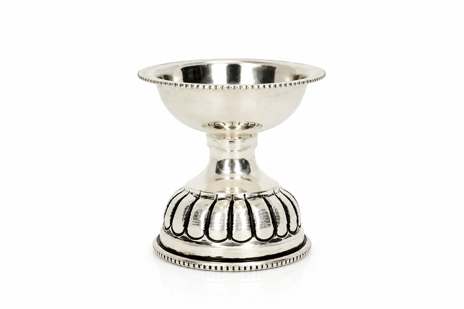 Mohnaa Padmika 925 sterling silver pedestal diya featuring a polished bowl, delicate beaded rim, and intricately patterned pedestal on a white background.