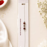 Rudra Shakti 925 Silver Rakhi featuring natural Rudraksha beads and a colorful centerpiece on a sterling silver chain, displayed in premium Mohnaa Jewels packaging.