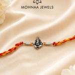 Vighnaharta Ganesh 925 Sterling Silver Rakhi featuring detailed Lord Ganesha motif with handcrafted saffron and red thread by Mohnaa Jewels
