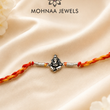 Vighnaharta Ganesh 925 Sterling Silver Rakhi featuring detailed Lord Ganesha motif with handcrafted saffron and red thread by Mohnaa Jewels