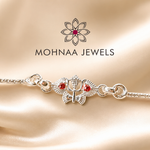 silver rakhi featuring sacred Om and Trishul design with red stone accents on a premium silver chain by Mohnaa Jewels
