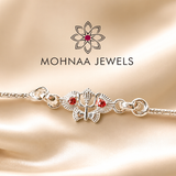 silver rakhi featuring sacred Om and Trishul design with red stone accents on a premium silver chain by Mohnaa Jewels