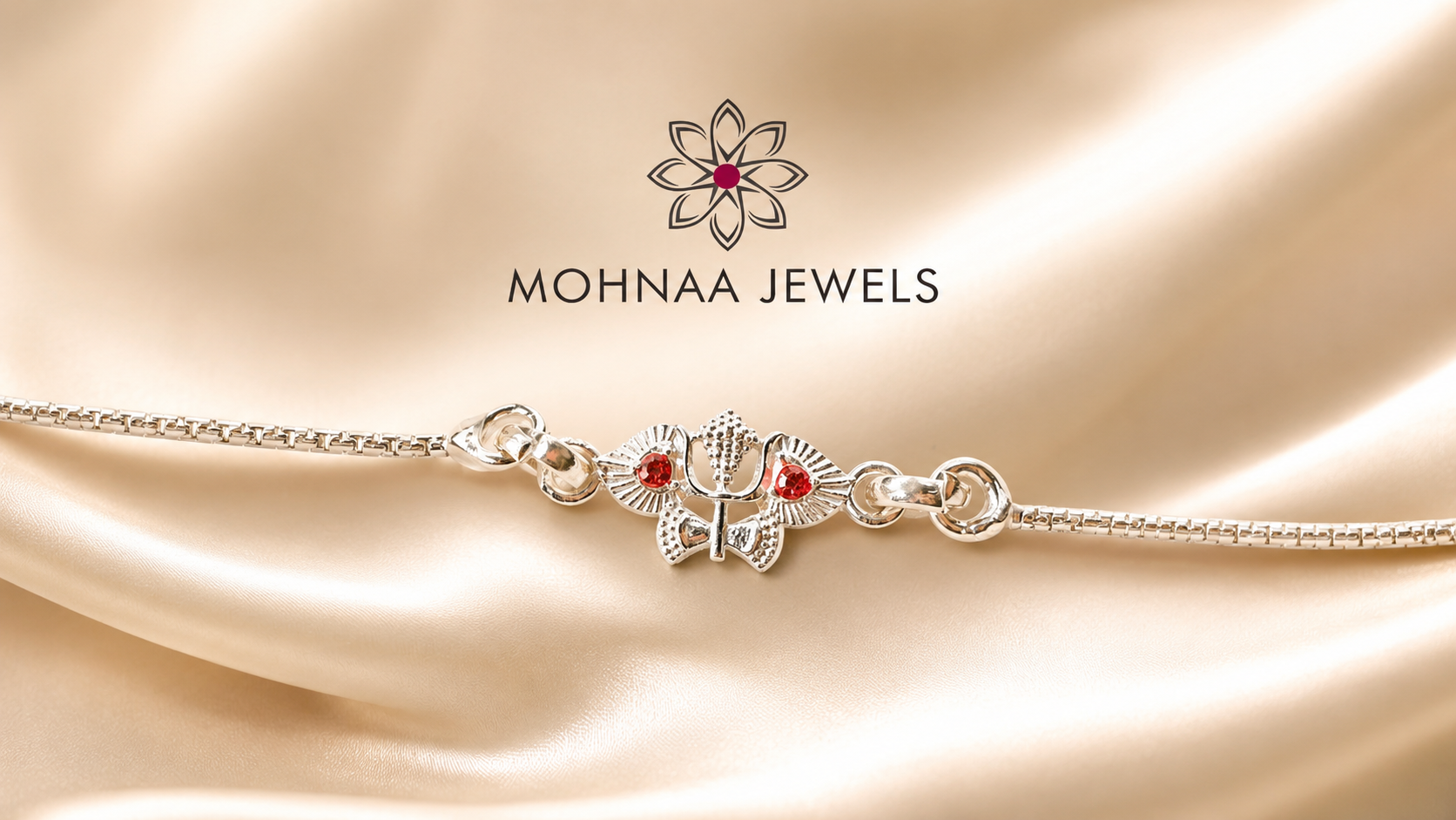 silver rakhi featuring sacred Om and Trishul design with red stone accents on a premium silver chain by Mohnaa Jewels