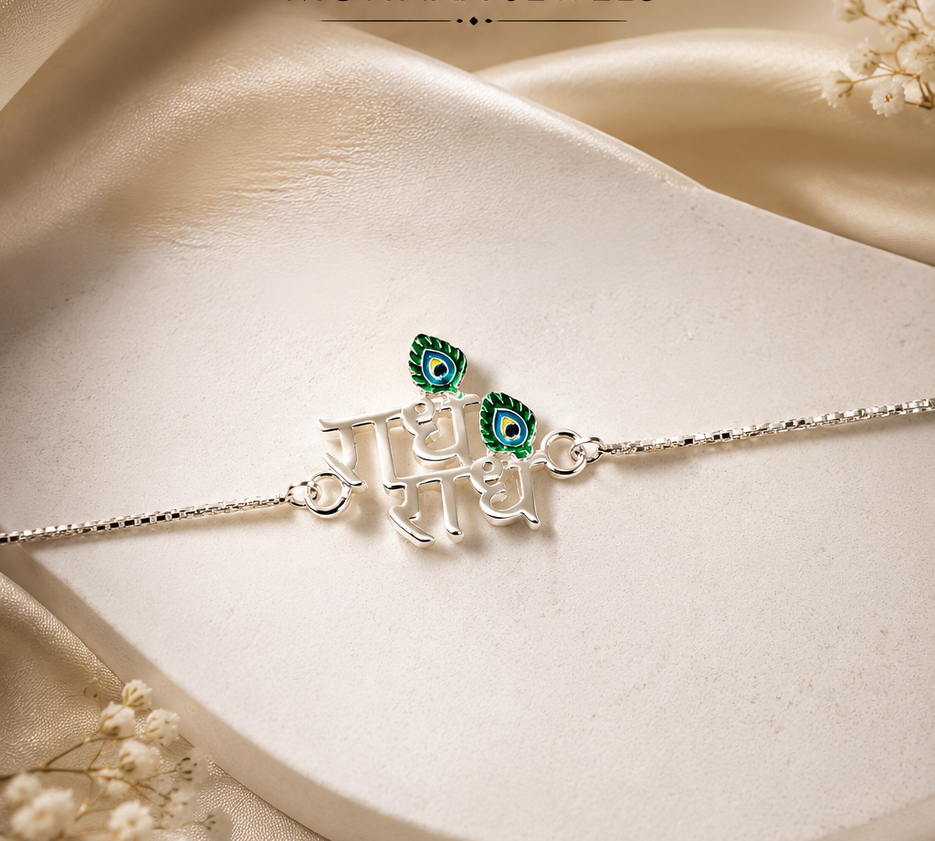 "Radhe Radhe 925 Sterling Silver Rakhi featuring an elegant Radhe Radhe script design with peacock feather accents on an adjustable sterling silver chain, handcrafted for Raksha Bandhan by Mohnaa Jewels."