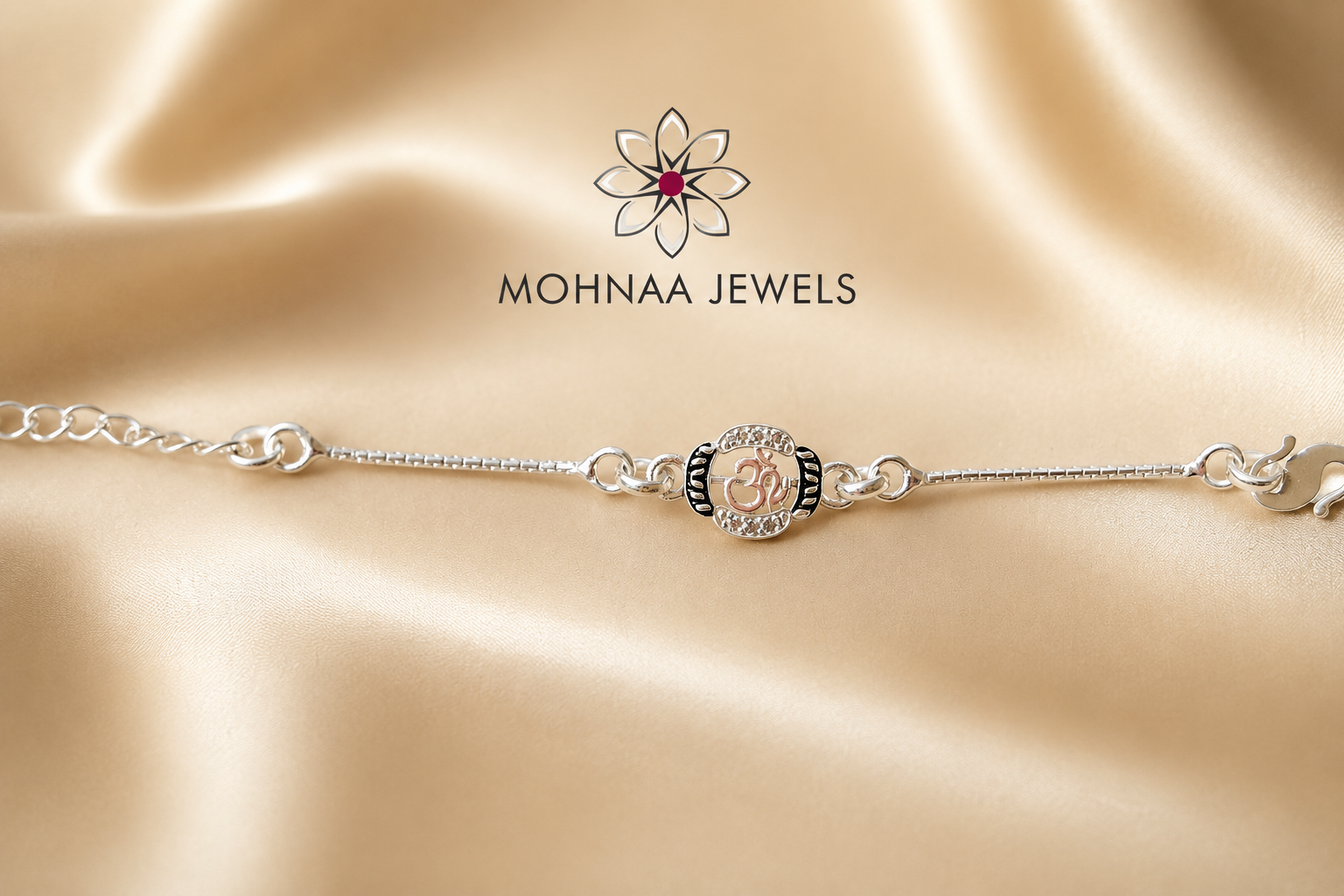 "Om 925 Silver Rakhi featuring a sacred Om symbol with sparkling stone embellishments on an adjustable sterling silver chain, elegantly displayed on a luxury satin background by Mohnaa Jewels."
