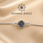 925 sterling silver rakhi bracelet featuring sacred Swastik motif with zircon embellishments and adjustable silver chain by Mohnaa Jewels