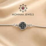 925 sterling silver rakhi bracelet featuring sacred Swastik motif with zircon embellishments and adjustable silver chain by Mohnaa Jewels