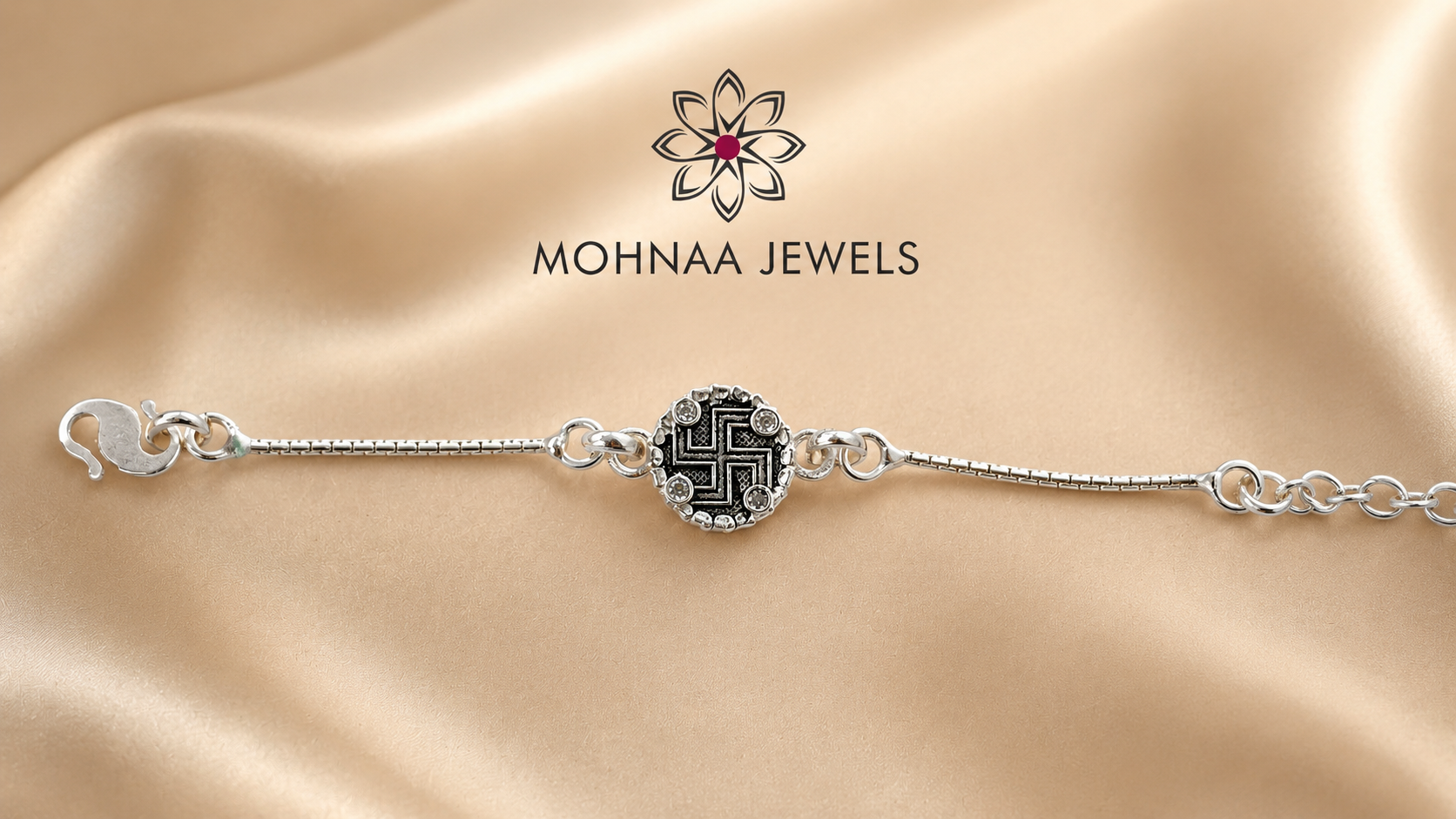 silver rakhi bracelet featuring sacred Swastik motif with zircon embellishments and adjustable silver chain by Mohnaa Jewels